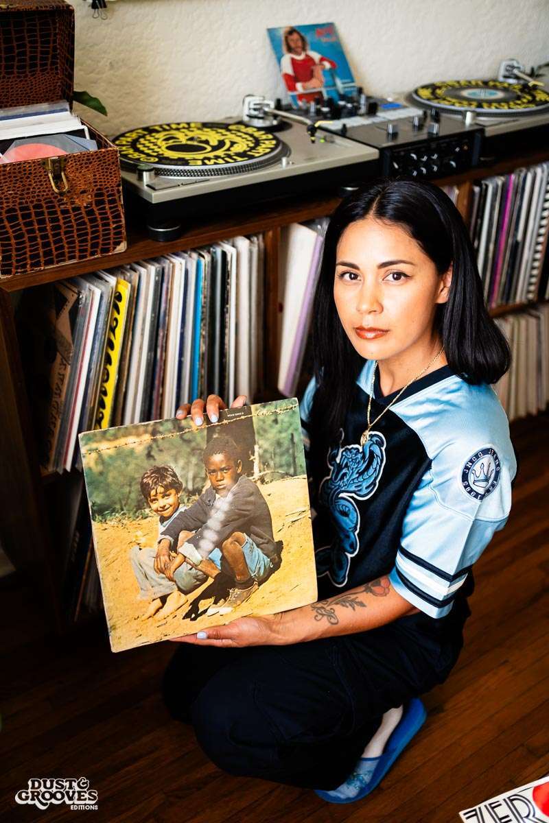 Melissa Dueñas, aka Sonrisita, a vinyl record collectors, photographed with her at her home in Los Angeles, CA for Dust & Grooves Volume 2 book.