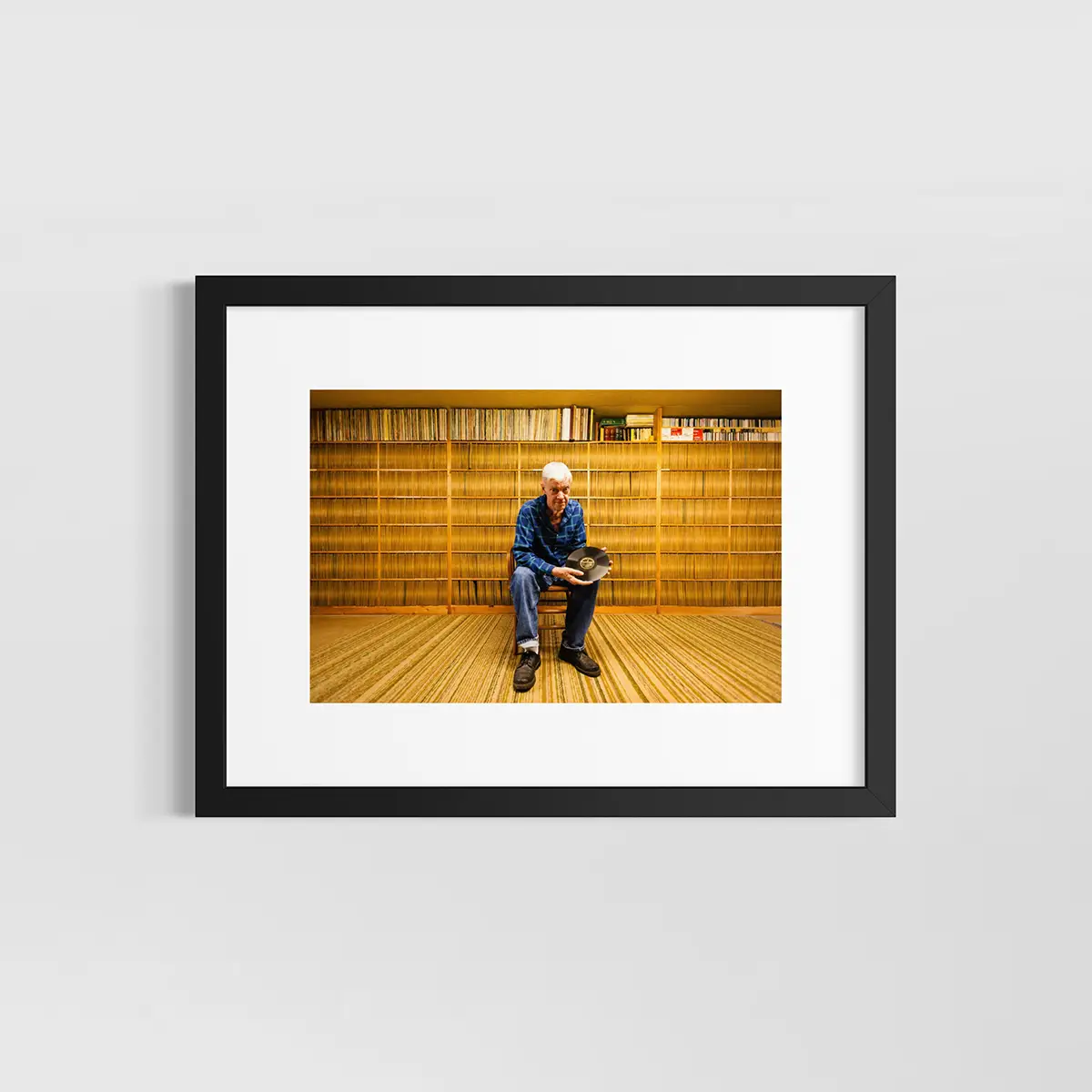 Joe Bussard. Frederick, MD. Joe Bussard sitting in his basement with some of the rarest 78s in existence. The brown paper record jackets behind him are all uniformly discolored in the middle as a result of Joe’s hands sorting and searching through them for the past 60 years.