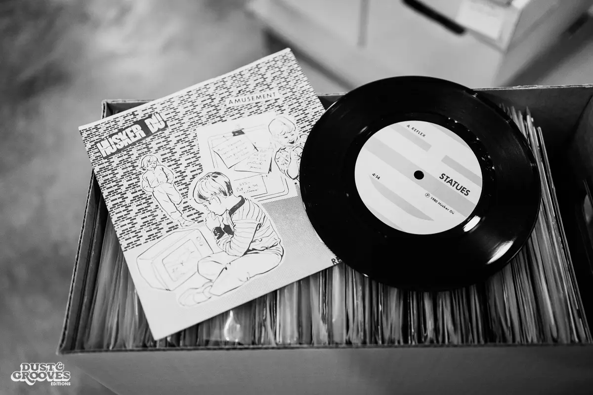 KEXP music director Kevin Cole in his home record basement in Seattle, pictured with shelves of vinyl and personal music memorabilia for Dust & Grooves Volume 2.