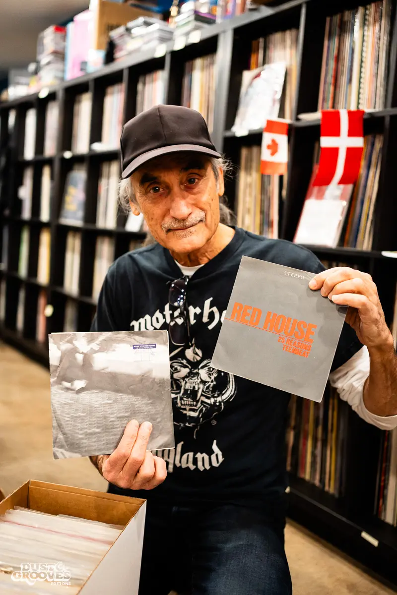 KEXP music director Kevin Cole in his home record basement in Seattle, pictured with shelves of vinyl and personal music memorabilia for Dust & Grooves Volume 2.