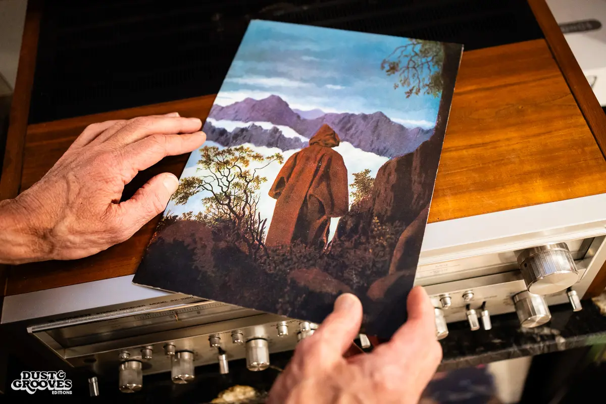 KEXP music director Kevin Cole in his home record basement in Seattle, pictured with shelves of vinyl and personal music memorabilia for Dust & Grooves Volume 2.