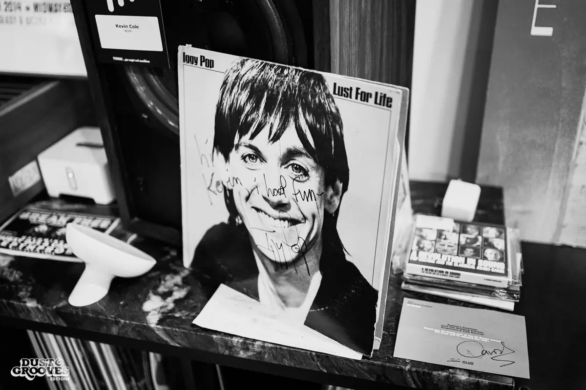 KEXP music director Kevin Cole in his home record basement in Seattle, pictured with shelves of vinyl and personal music memorabilia for Dust & Grooves Volume 2.