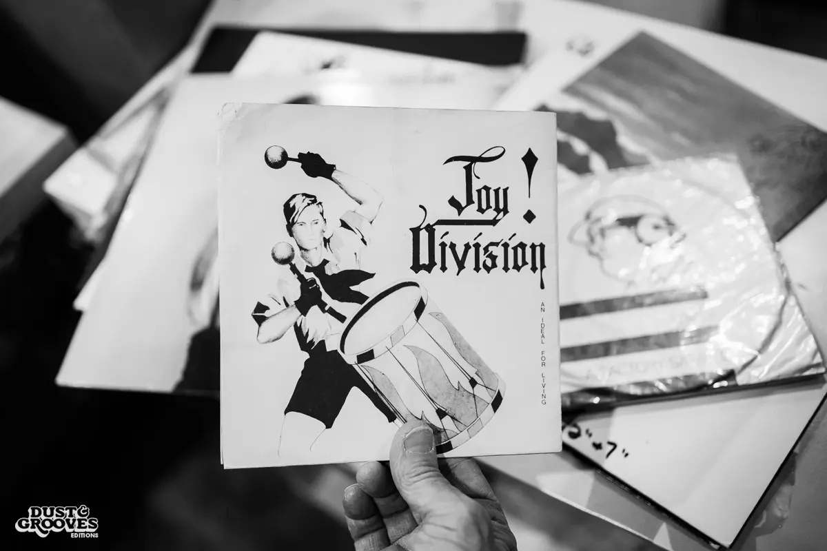 KEXP music director Kevin Cole in his home record basement in Seattle, pictured with shelves of vinyl and personal music memorabilia for Dust & Grooves Volume 2.