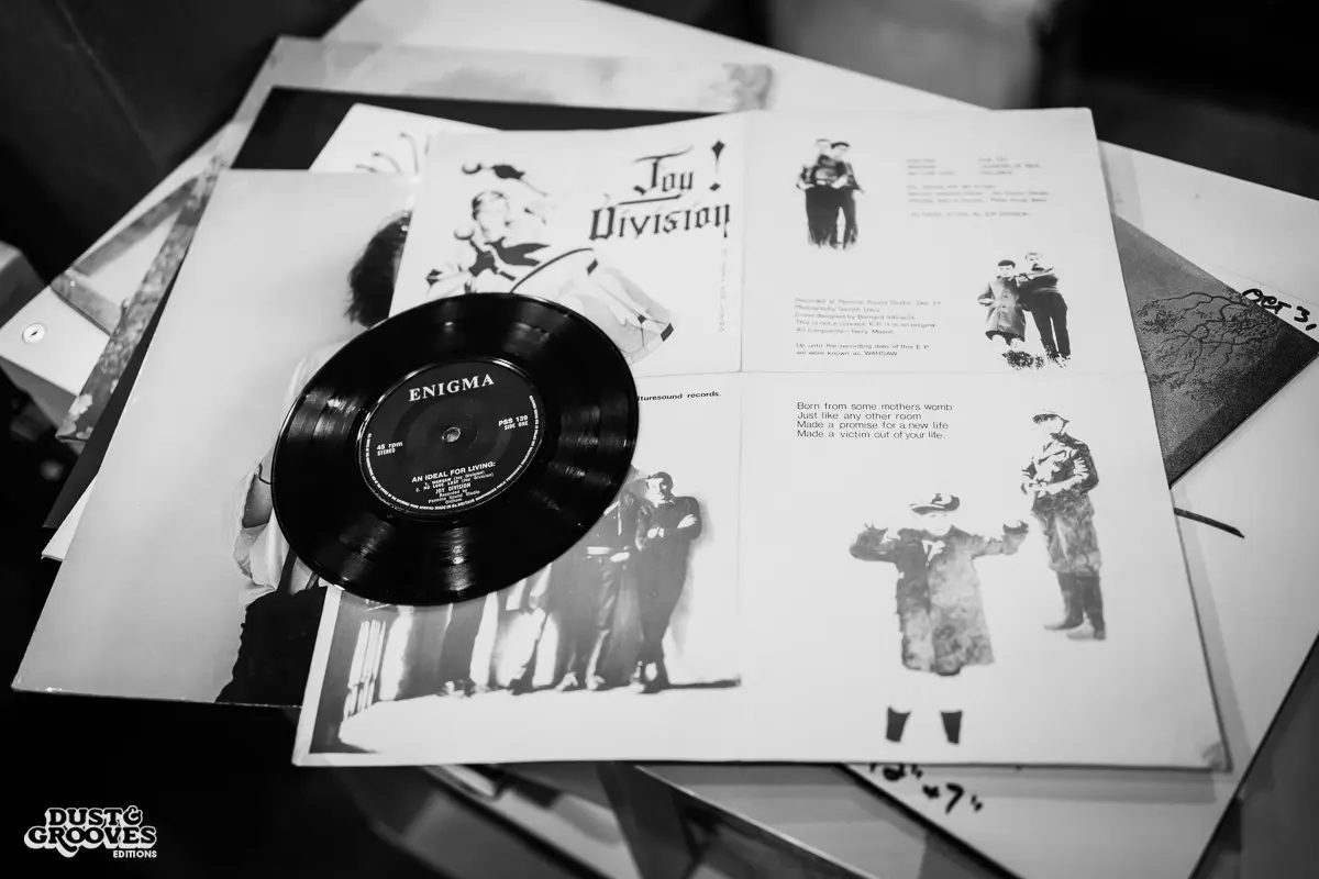 KEXP music director Kevin Cole in his home record basement in Seattle, pictured with shelves of vinyl and personal music memorabilia for Dust & Grooves Volume 2.