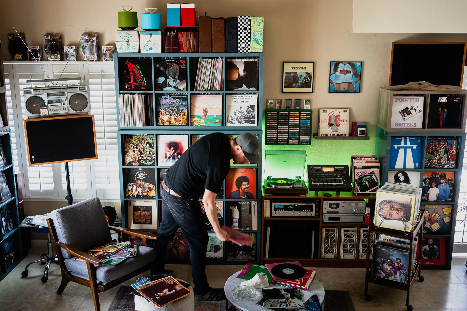 DJ Platurn, a music producer and vinyl record collector, is pictured in his Vallejo, CA home with shelves of vinyl and personal music memorabilia for Dust & Grooves Volume 2.