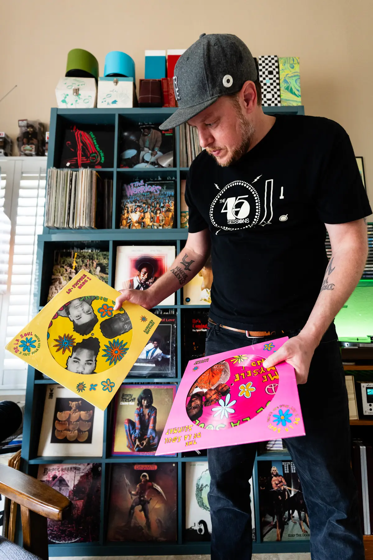 DJ Platurn, a music producer and vinyl record collector, is pictured in his Vallejo, CA home with shelves of vinyl and personal music memorabilia for Dust & Grooves Volume 2.