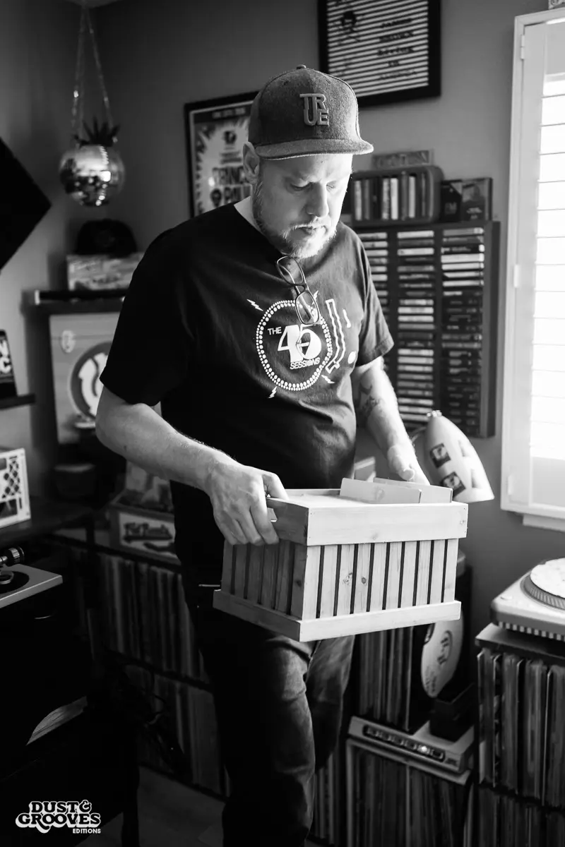DJ Platurn, a music producer and vinyl record collector, is pictured in his Vallejo, CA home with shelves of vinyl and personal music memorabilia for Dust & Grooves Volume 2.