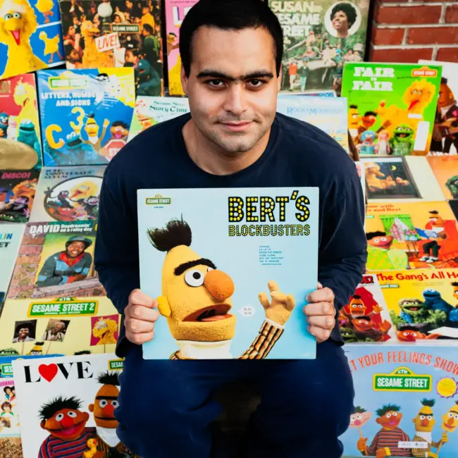 Dante Candelora, a vinyl record collector, is pictured in South Philadelphia with his collection of Sesame Street records, including Big Bird and Bert albums, photographed for Dust & Grooves Vol. 1.