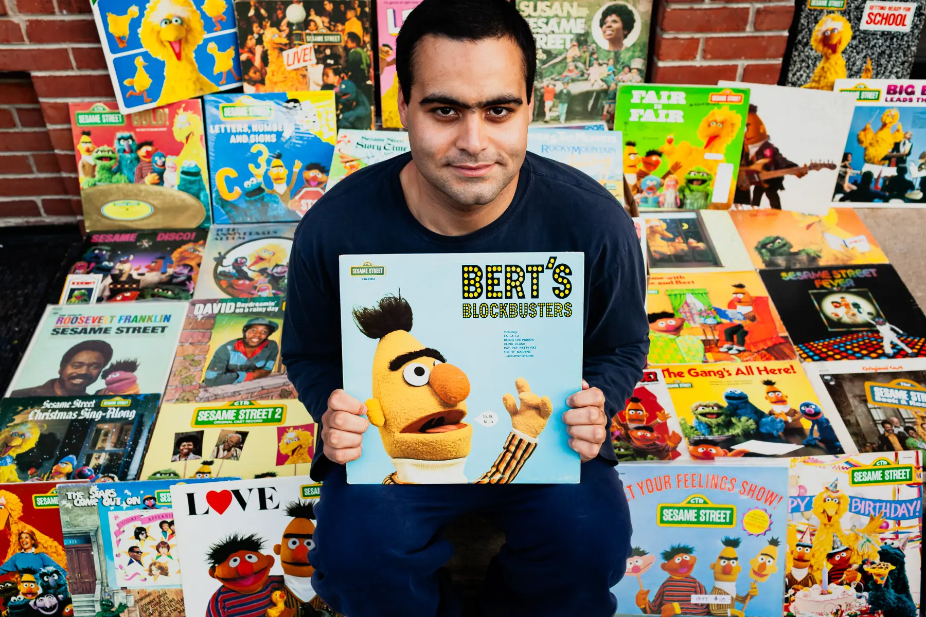 Dante Candelora, a vinyl record collector, is pictured in South Philadelphia with his collection of Sesame Street records, including Big Bird and Bert albums, photographed for Dust & Grooves Vol. 1.